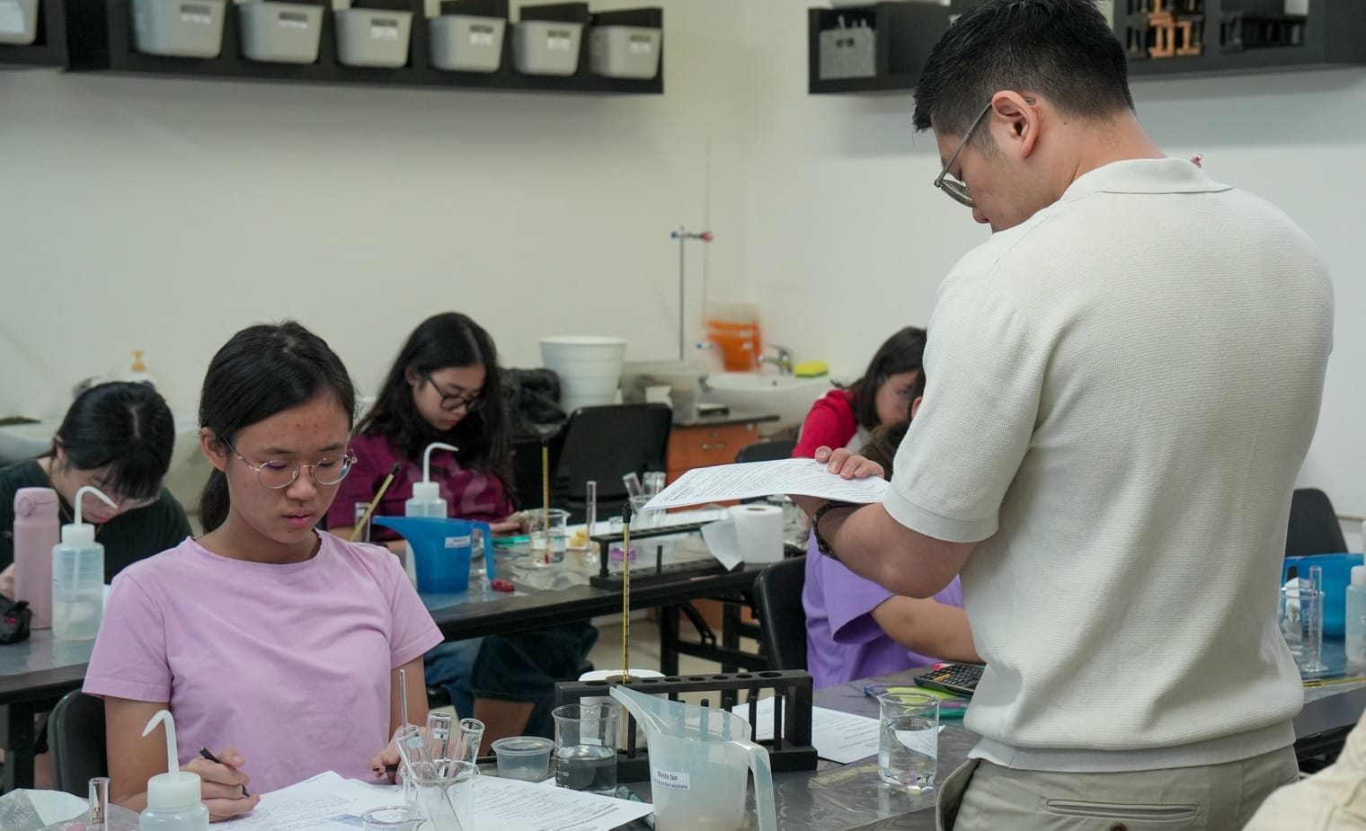 Biology Tuition class in Singapore with students conducting practical science experiments under the guidance of an experienced tutor.